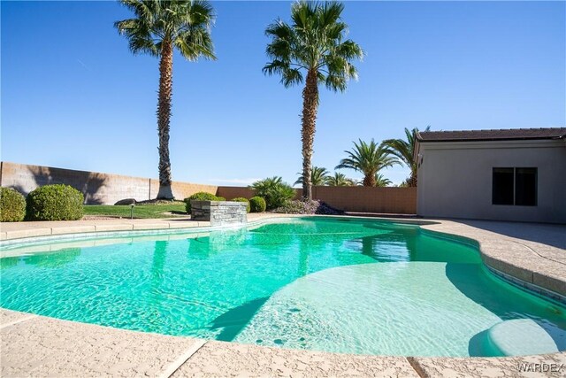 outdoor pool with a patio and fence private yard