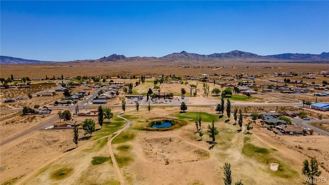 drone / aerial view featuring a residential view, a mountain view, and a desert view