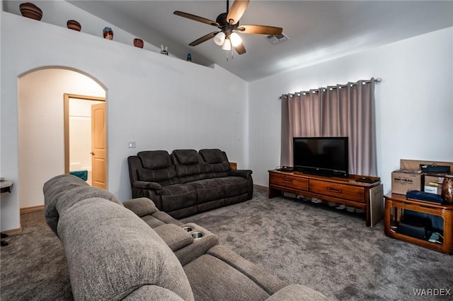 living area with a ceiling fan, visible vents, vaulted ceiling, arched walkways, and carpet floors
