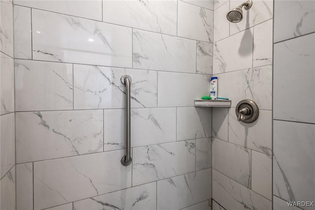 bathroom with tiled shower