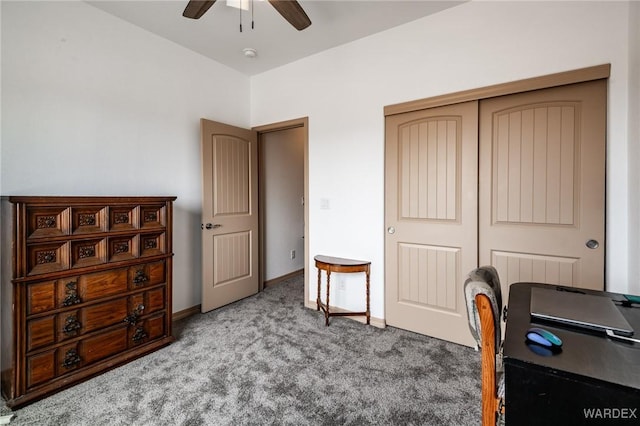 carpeted office featuring baseboards and a ceiling fan