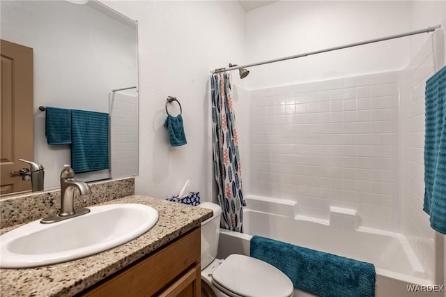 full bathroom with shower / bath combination with curtain, toilet, and vanity