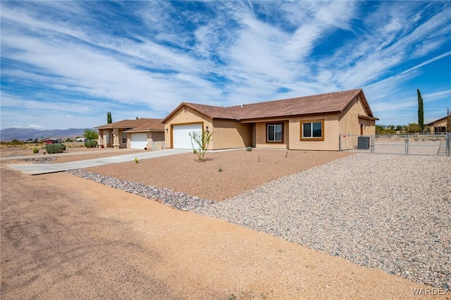 single story home featuring driveway, a garage, stucco siding, and fence
