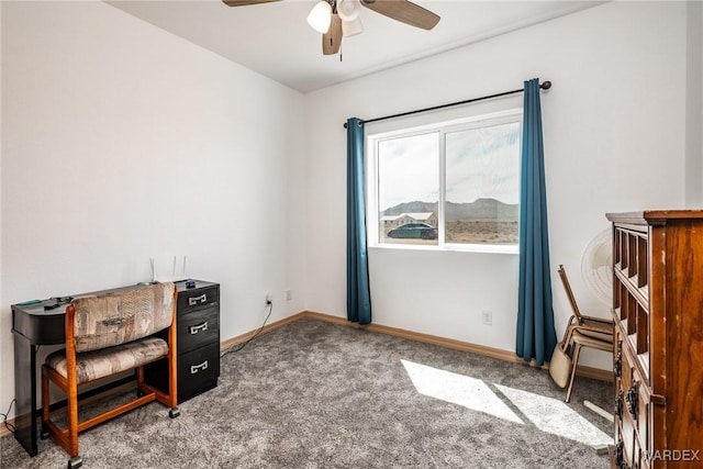 sitting room featuring baseboards, a ceiling fan, and carpet floors
