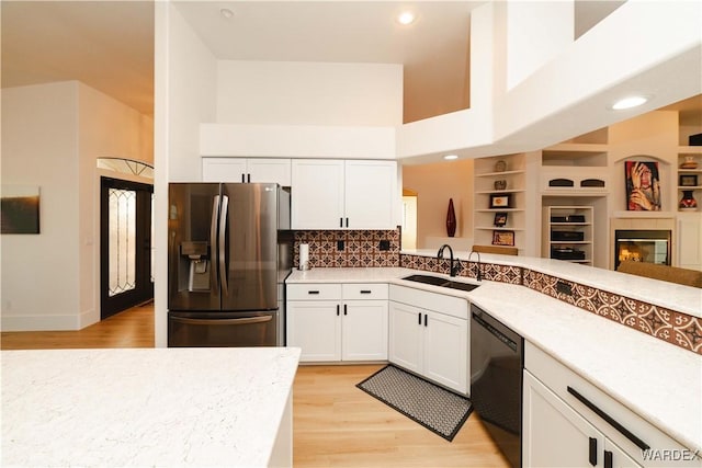 kitchen featuring a sink, white cabinetry, black dishwasher, open floor plan, and stainless steel fridge with ice dispenser