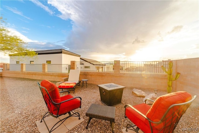 patio terrace at dusk with a fenced backyard