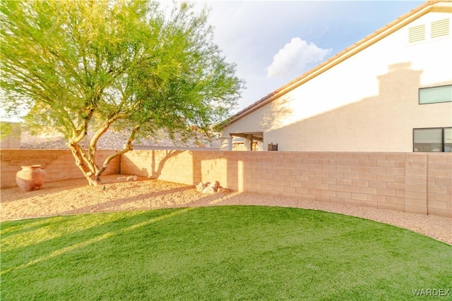 view of yard featuring a fenced backyard and visible vents