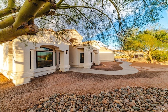 rear view of property with stucco siding