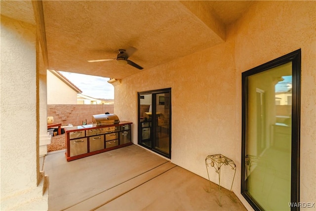 view of patio / terrace with exterior kitchen, a grill, fence, and a ceiling fan