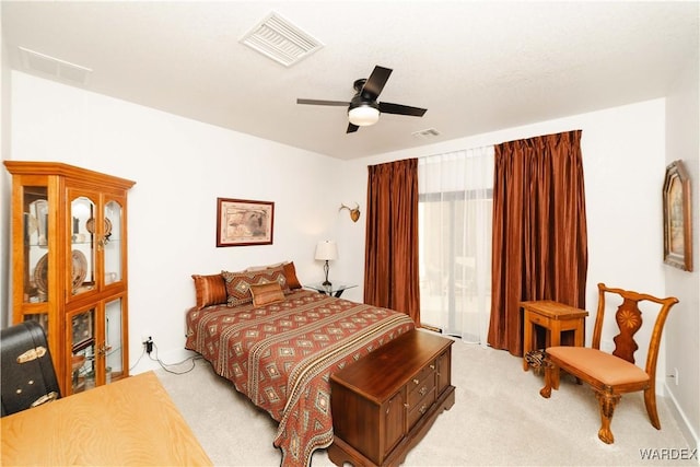 bedroom with visible vents, ceiling fan, and light carpet