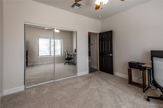 office with light carpet, ceiling fan, visible vents, and baseboards