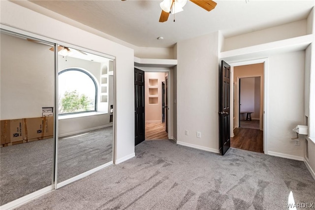 unfurnished bedroom featuring ceiling fan, carpet flooring, and baseboards