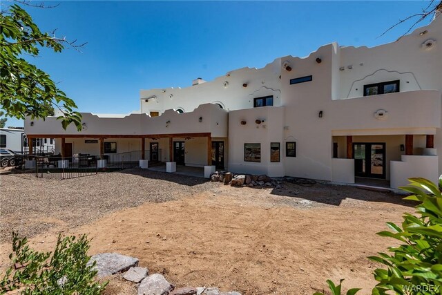 back of house featuring stucco siding