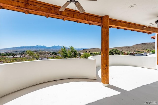 view of patio with a mountain view and ceiling fan