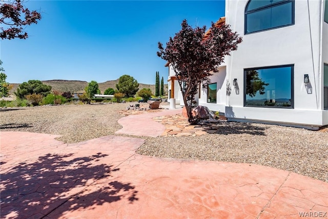 view of yard featuring a patio area and a mountain view