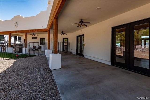 view of patio / terrace featuring ceiling fan, french doors, and fence