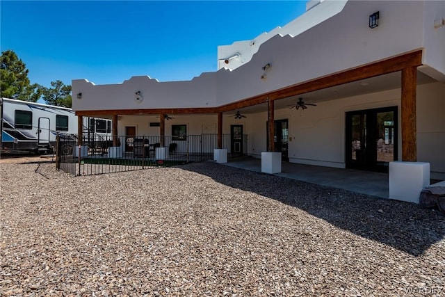 back of house with a patio area, fence, a ceiling fan, and stucco siding