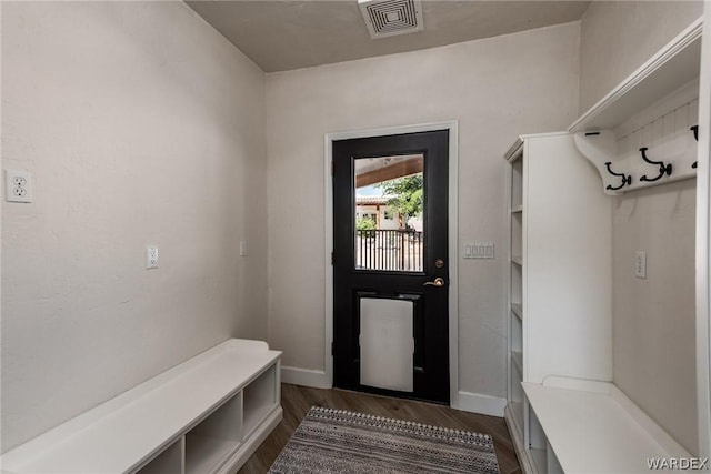 mudroom with dark wood-style floors, visible vents, and baseboards