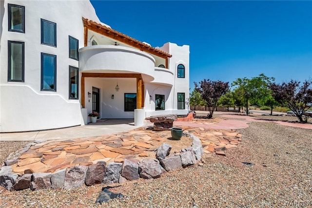 back of house featuring a patio area and stucco siding