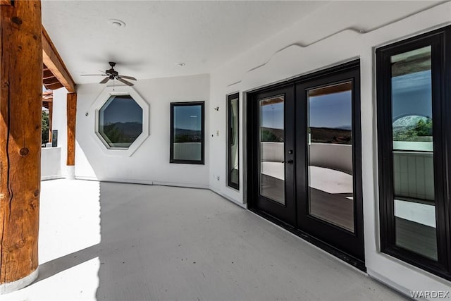 view of patio with french doors and a ceiling fan