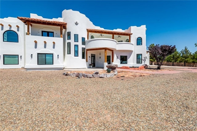 back of property with a patio area and stucco siding