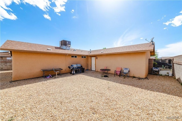 3144 N Prescott St, Kingman, AZ 86401 - rear view of property with central AC unit, stucco siding, and fence