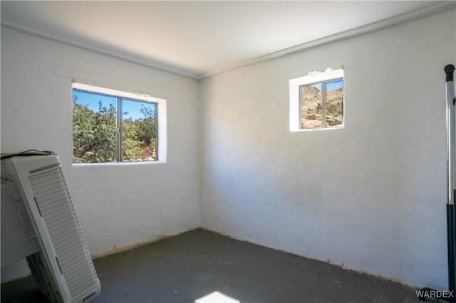 unfurnished room featuring concrete flooring