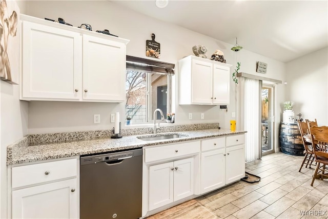 kitchen with a sink, plenty of natural light, white cabinets, and dishwasher