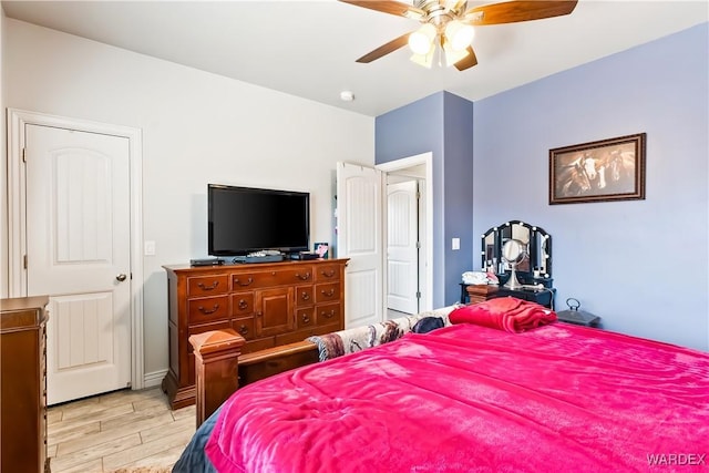 bedroom with ceiling fan and light wood-style flooring