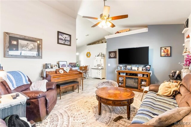 living room featuring lofted ceiling, ceiling fan, and wood finished floors