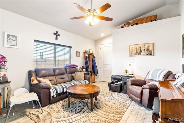 living area with lofted ceiling, ceiling fan, and light wood finished floors