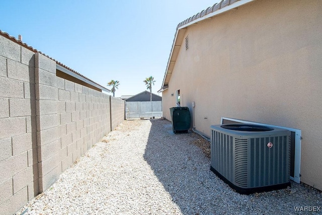 view of yard featuring a fenced backyard and central AC