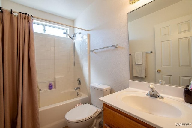 full bathroom with shower / bath combo with shower curtain, vanity, and toilet