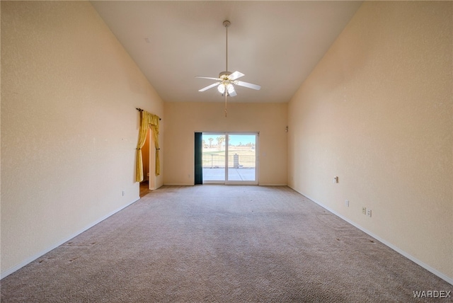 empty room featuring light carpet, high vaulted ceiling, and a ceiling fan