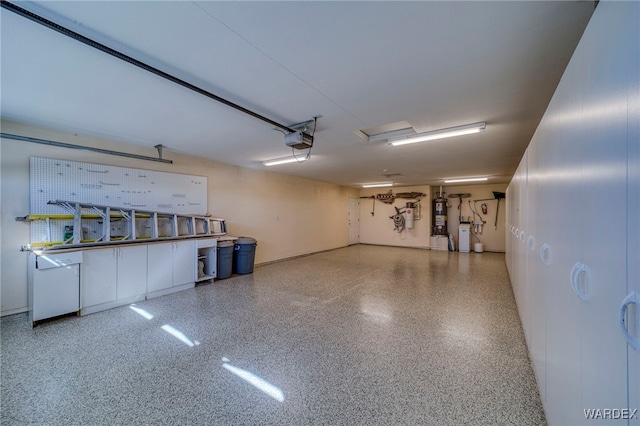 garage with a garage door opener and strapped water heater