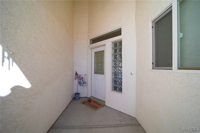 entrance to property featuring stucco siding