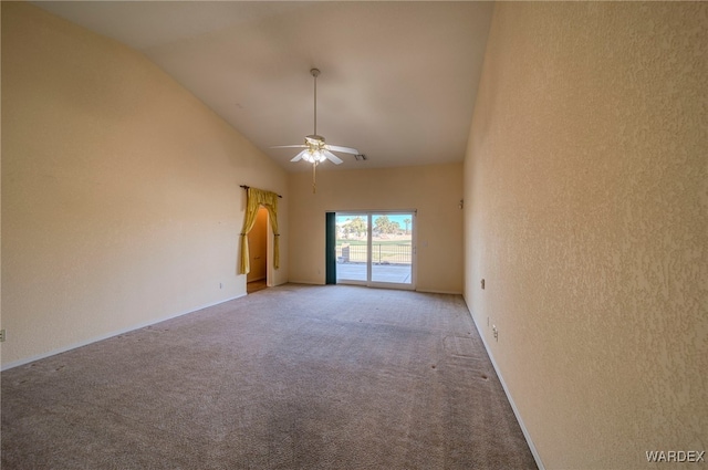 spare room with high vaulted ceiling, light colored carpet, and a ceiling fan