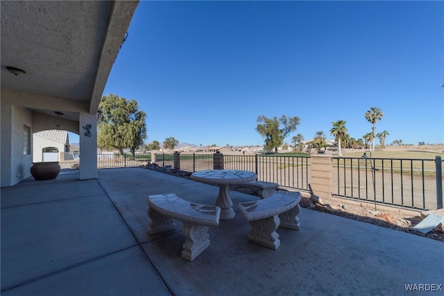 view of patio featuring fence