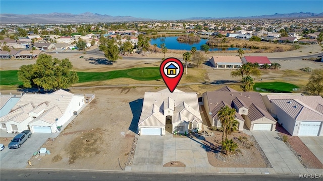 birds eye view of property with view of golf course, a water and mountain view, and a residential view