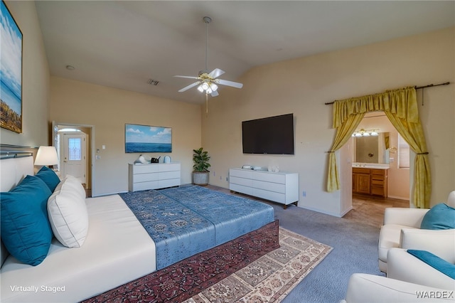 bedroom featuring baseboards, visible vents, connected bathroom, lofted ceiling, and carpet floors