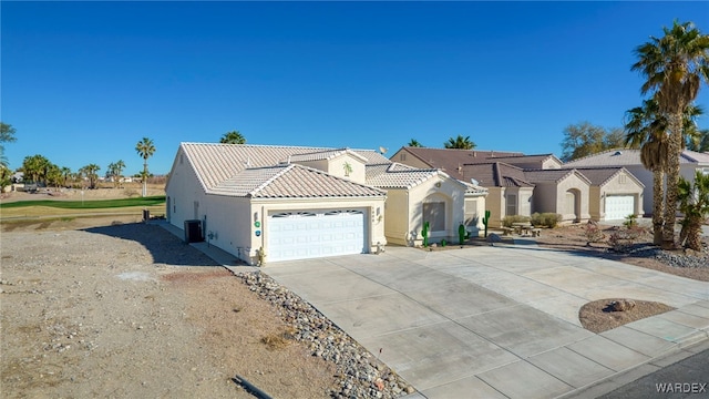 view of front of house featuring a tile roof, stucco siding, a garage, cooling unit, and driveway