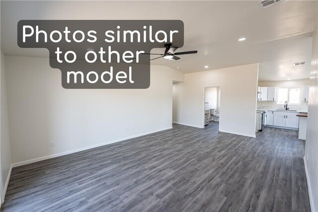 7674 E Oxbow Dr, Kingman, AZ 86401 - unfurnished living room with a ceiling fan, dark wood-style floors, baseboards, recessed lighting, and a sink