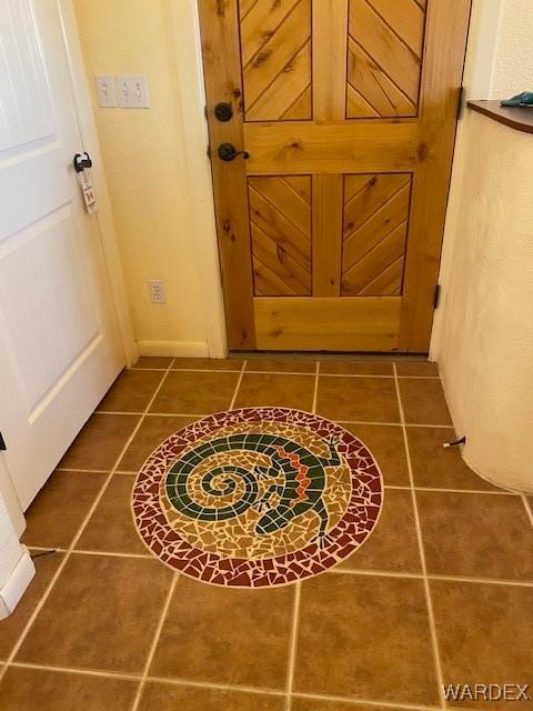 interior space with dark tile patterned flooring