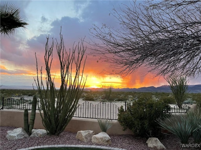 view of yard featuring a fenced front yard, a gate, and a mountain view