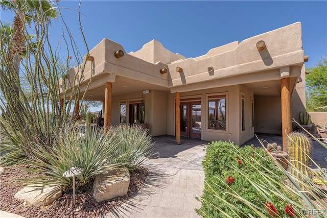 property entrance featuring french doors and a patio