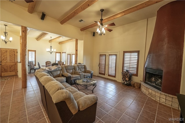 living room featuring beam ceiling, plenty of natural light, a fireplace, and visible vents