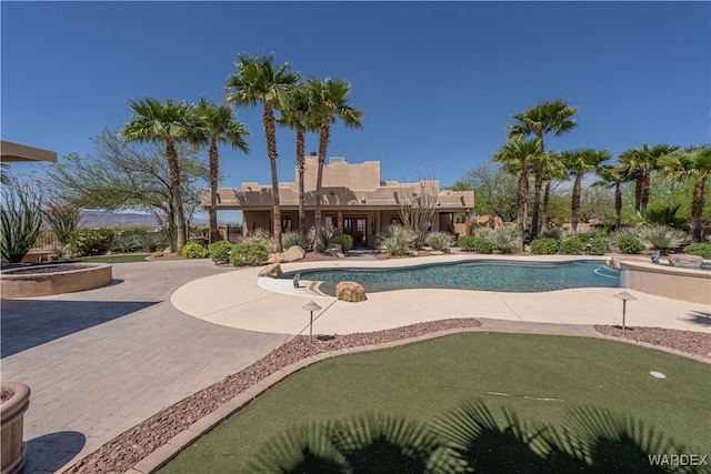 outdoor pool with a patio area