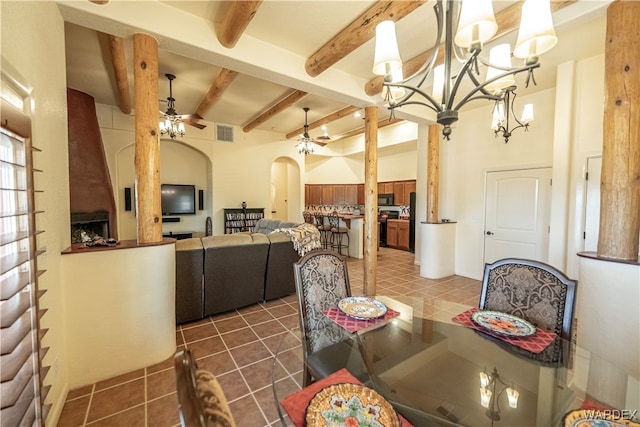 dining room featuring arched walkways, beam ceiling, visible vents, dark tile patterned floors, and ceiling fan with notable chandelier