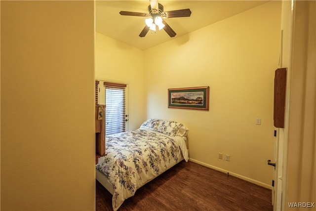 bedroom with ceiling fan, baseboards, and dark wood-type flooring