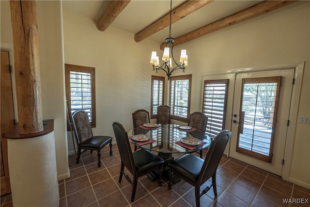 dining area featuring dark tile patterned flooring, french doors, beamed ceiling, and a notable chandelier